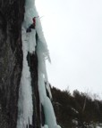 At the top, the ice overhangs; the route finishes by mounting the free-hanging pillar to the right