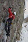 Joe climbs the initial section of ice that leads to an overhanging crack; David sets up in the background to shoot The Apology