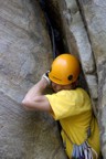 Squeezing out of the chimney at the start; I thought this was the crux of the route