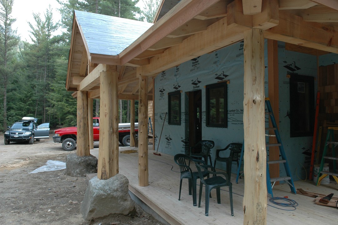 The completed front porch -- 2x4 T&G white cedar floor, 2x6 T&G white cedar ceiling, cedar posts, and pine timber framing