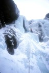 The third pitch (WI3) goes to the right of the cave and up to easier ice
