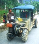 Typical transport in the countryside of Yangshuo; a cross between a tractor, and ATV, and a pick-up. Note the exposed fly-wheel in the front.